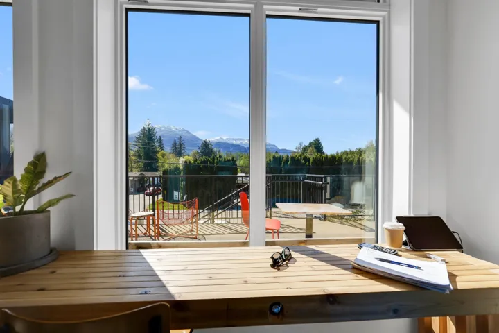 Large window and sliding glass door leading to an outdoor deck