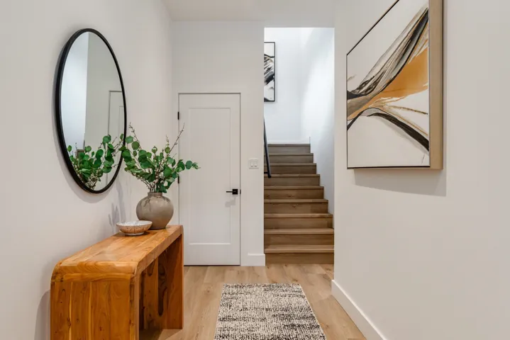 Entryway with light wood-type flooring and stairs