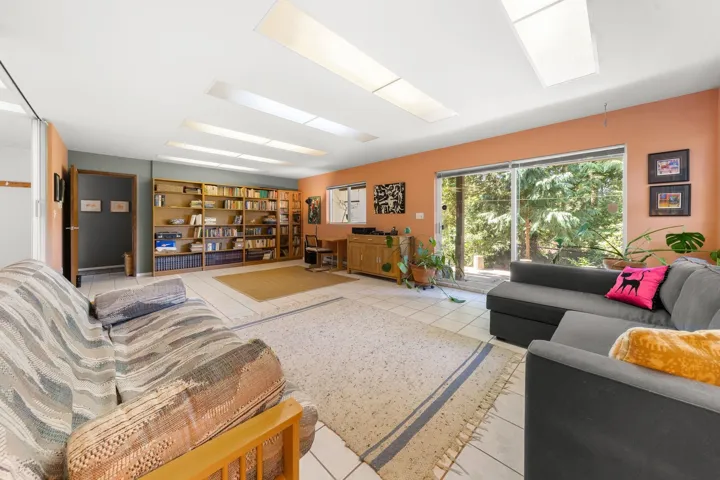 Spacious interior featuring large format tile flooring and multiple skylights
