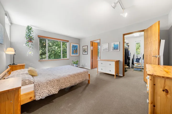Room featuring broadloom carpet, light gray walls, and light wood-finish doors