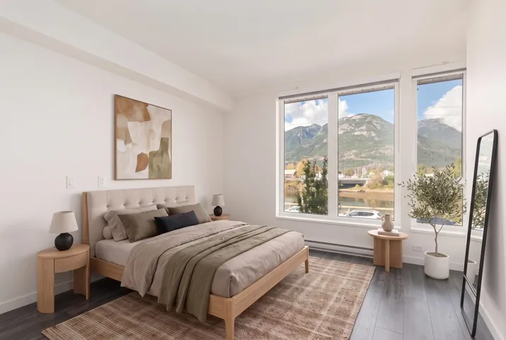 Expansive floor-to-ceiling windows featuring prominent mountain scenery and natural light, complemented by dark wood-finish flooring