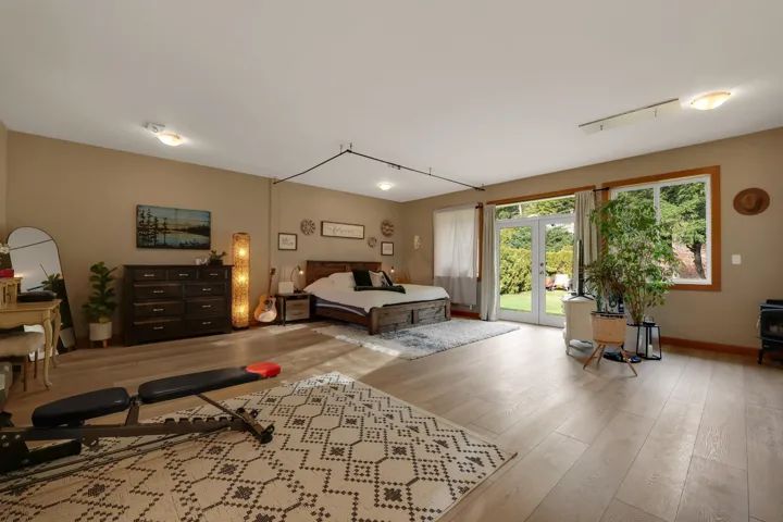 Bedroom with hardwood / wood-style floors, access to exterior, and french doors