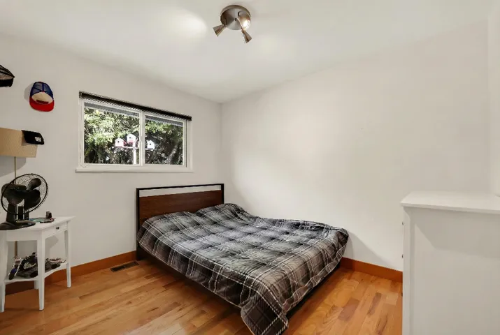 Bedroom featuring light wood-type flooring and baseboards