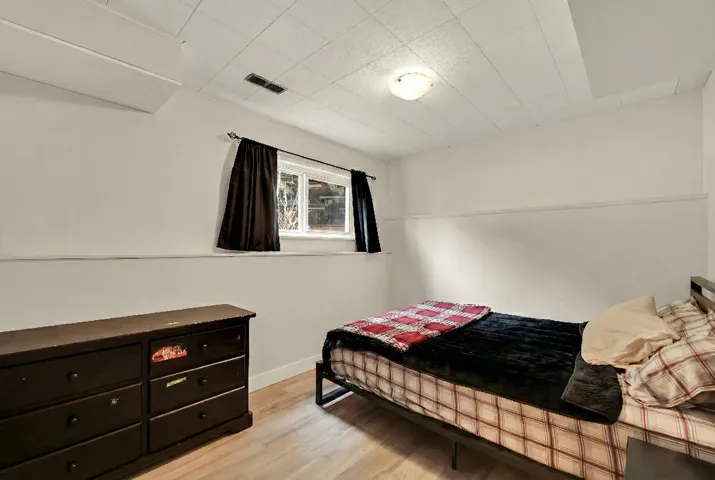 Bedroom featuring light wood-style flooring and baseboards