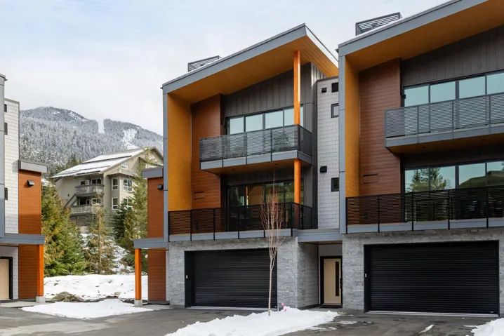 Exterior space with a double car garage, driveway, and a mountain view.