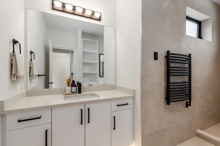 Primary bedroom featuring electric blackout blinds,  recessed lighting and light wood-style flooring