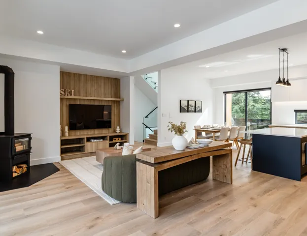 Living area with recessed lighting, stairway, light wood-style flooring, and a wood stove