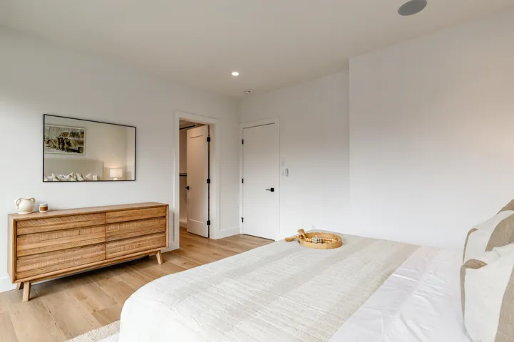 Primary bedroom featuring electric blackout blinds, vents, wood-like finished floors, recessed lighting, a mountain view, and access to exterior private deck.