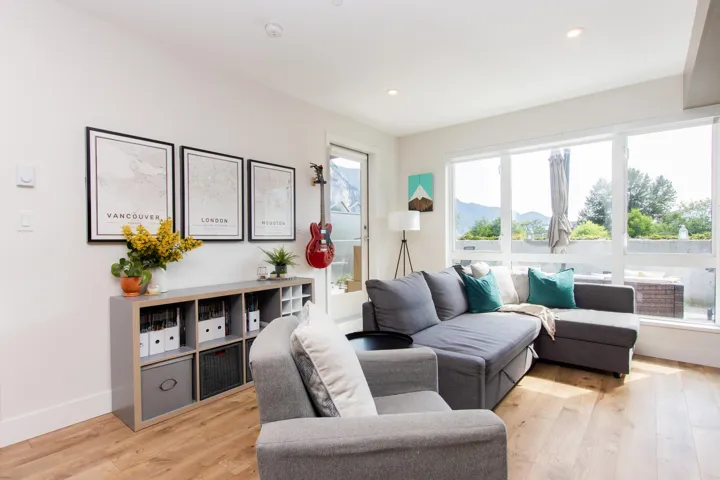 Living room featuring light wood finished floors, a mountain view, and recessed lighting
