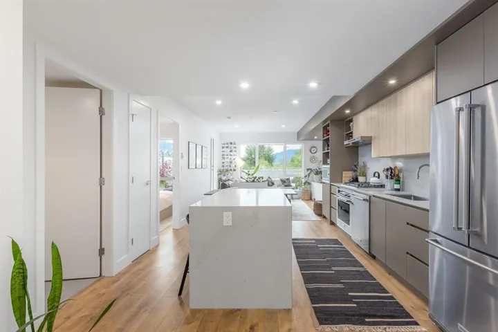 Kitchen featuring appliances with stainless steel finishes, modern cabinets, a center island, light wood-style floors, and recessed lighting