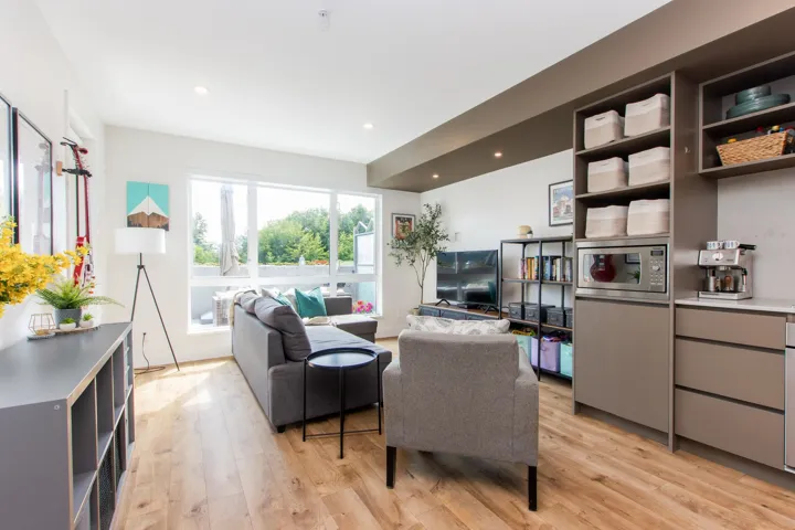 Living area with light wood-style floors and recessed lighting