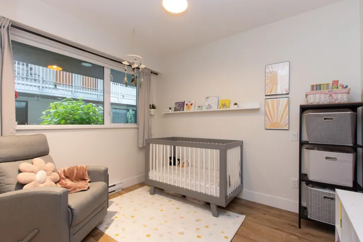 Bedroom featuring a baseboard radiator and wood finished floors