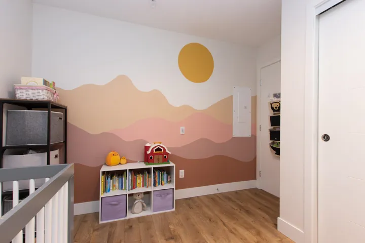 Bedroom featuring electric panel and wood finished floors