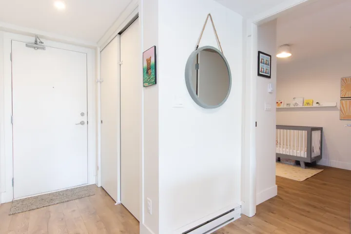 Hall featuring light wood finished floors and a baseboard radiator