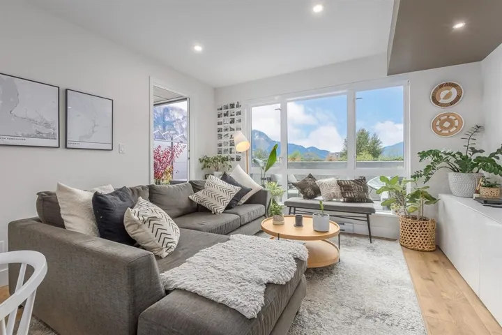Living area featuring light wood-style flooring and recessed lighting