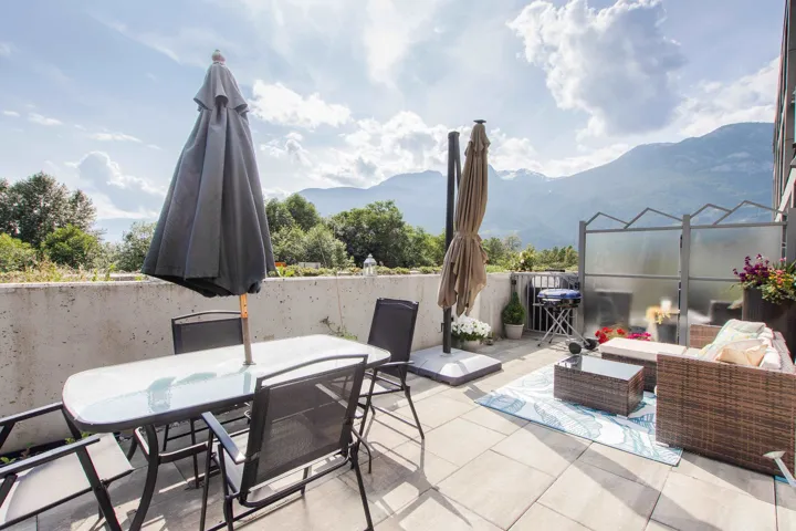 Fenced backyard with outdoor dining area and a mountain view