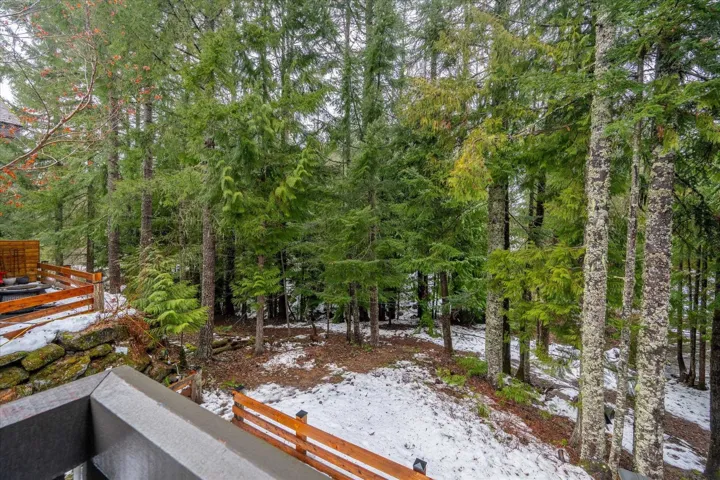 Yard layered in snow featuring a wooden deck