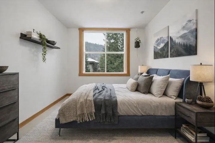 Carpeted bedroom featuring baseboards