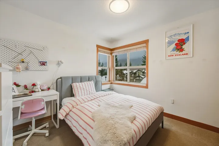 Bedroom with baseboards and carpet flooring