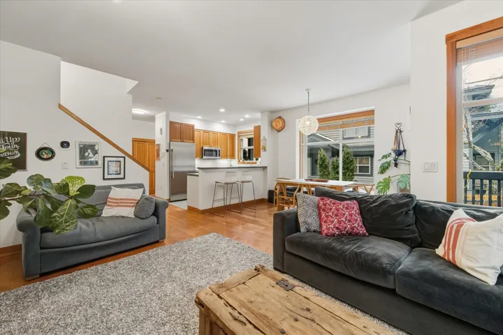 Living room featuring light wood-style flooring and hanging lights