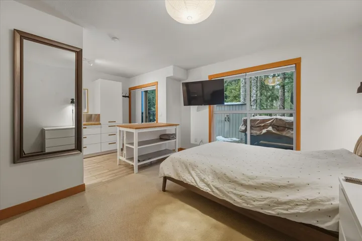 Bedroom featuring baseboards and light carpet