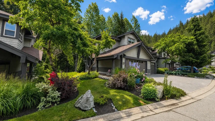 Residential property featuring multi-pane windows, a gabled roof, and attached garage