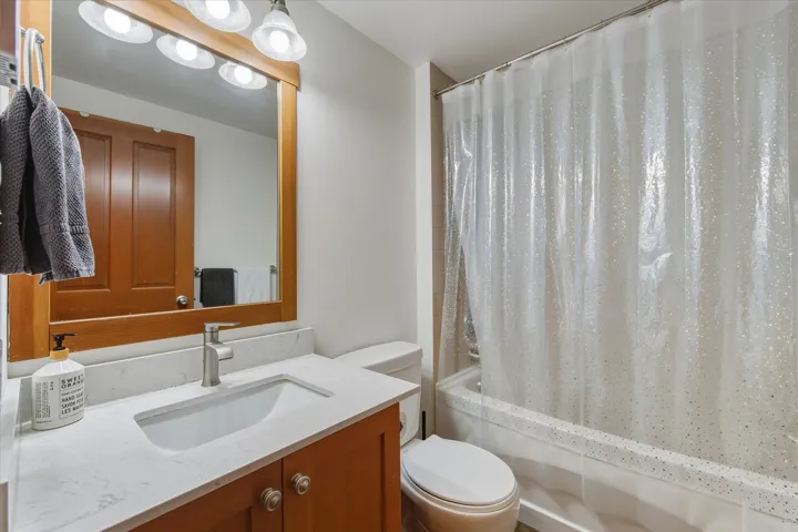 Full bathroom with vanity and shower / bath combination with curtain
