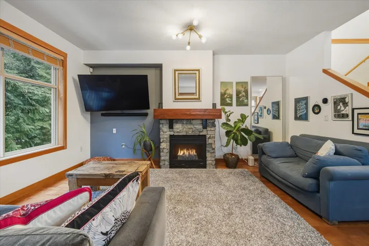 Living room with a fireplace and wood finished floors