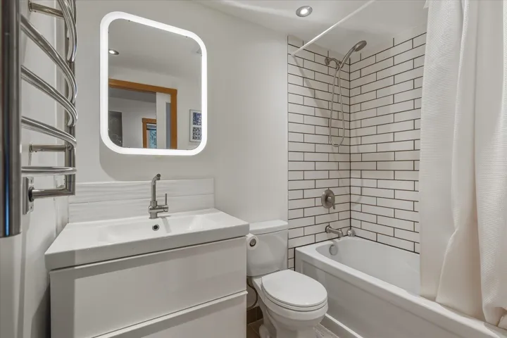 Full bathroom with shower / bath combo with shower curtain and vanity