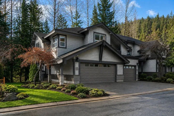 Multi-level residence featuring gray siding and dark trim