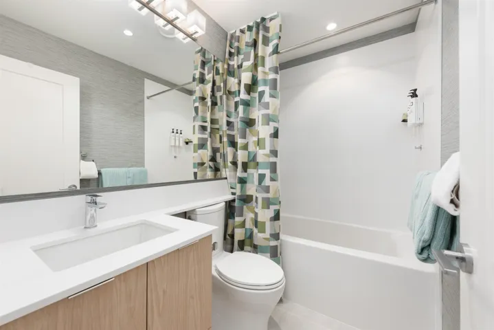 Full bath with vanity, shower / tub combo with curtain, and recessed lighting