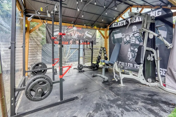 Exercise room featuring lofted ceiling