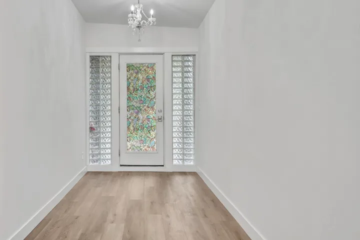 Foyer featuring a chandelier and light wood-style flooring