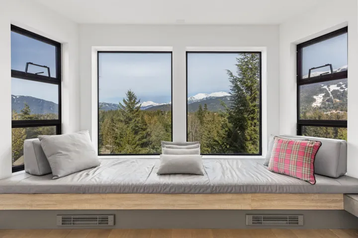Sitting room with a mountain view, visible vents, and plenty of natural light