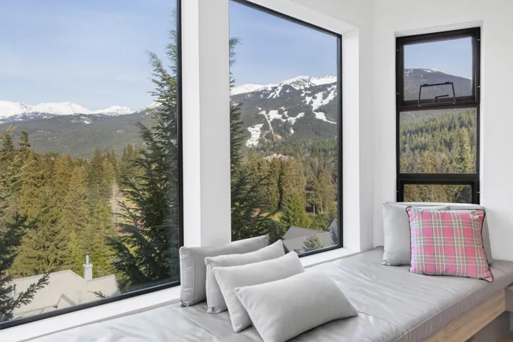 Bedroom featuring a wooded view and a mountain view