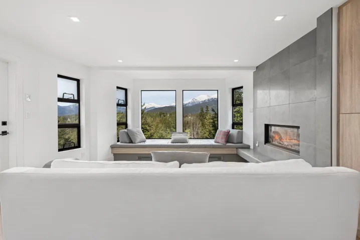 Living area featuring recessed lighting, a fireplace, and a mountain view
