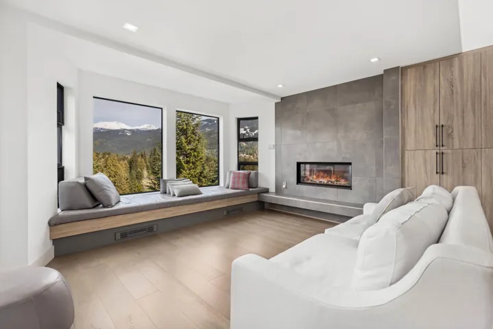 Living area featuring a mountain view, visible vents, recessed lighting, wood finished floors, and a tile fireplace