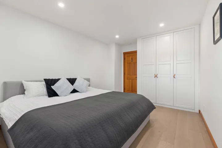 Bedroom with a closet, light wood-style flooring, recessed lighting, and baseboards