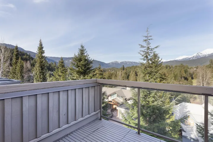 Balcony featuring a forest view and a mountain view