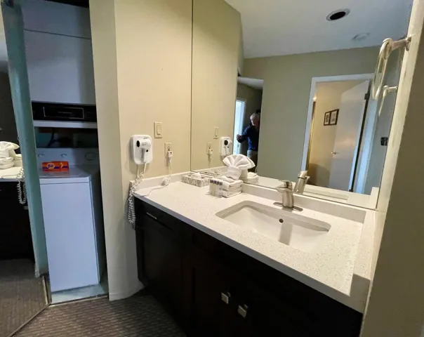 Bathroom featuring vanity and washer / clothes dryer