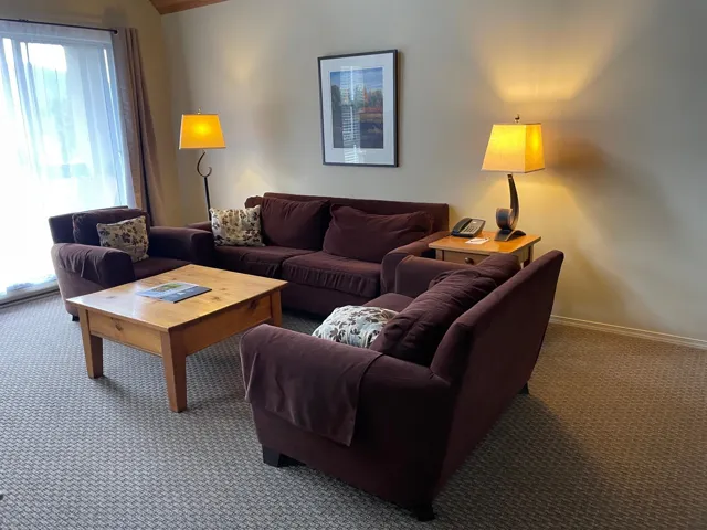 Carpeted living room featuring baseboards