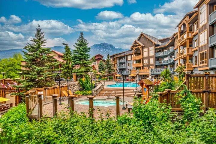 Community pool featuring a mountain view, a patio, and a community hot tub
