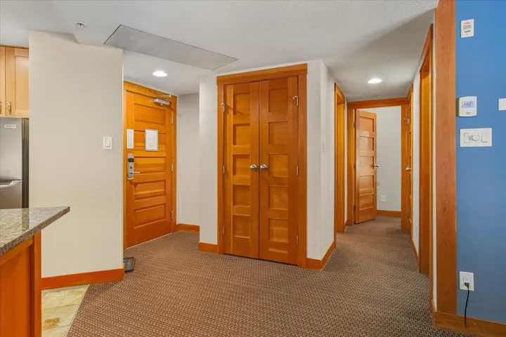 Hallway with carpet floors and recessed lighting