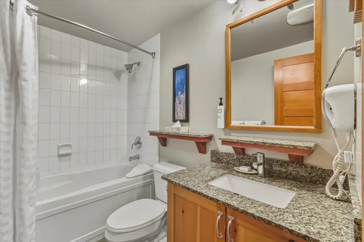 Full bath featuring shower / tub combo and vanity