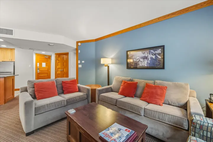 Carpeted living area with recessed lighting