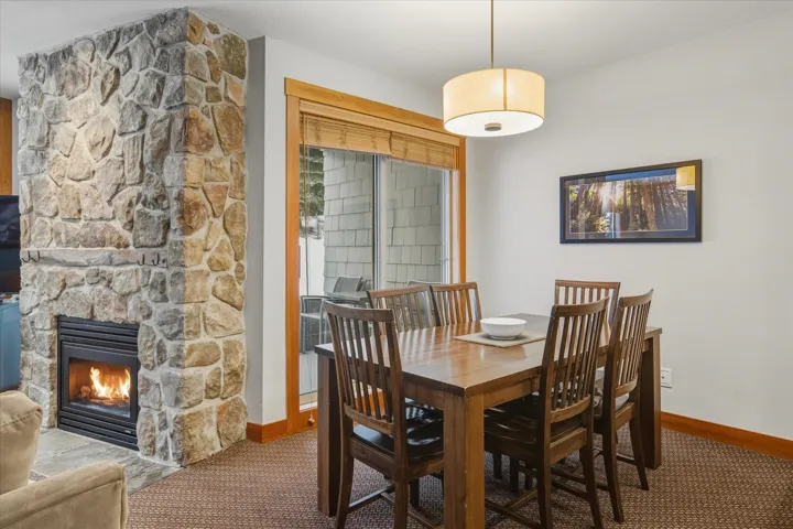 Dining space featuring a fireplace and carpet flooring