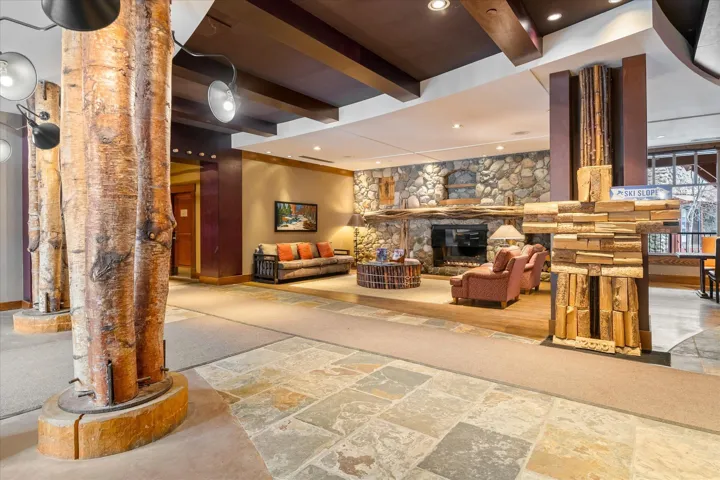 Common area with beamed ceiling and recessed lighting