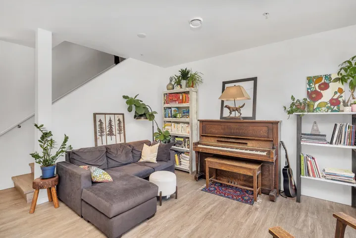 Living room with stairway and light wood finished floors
