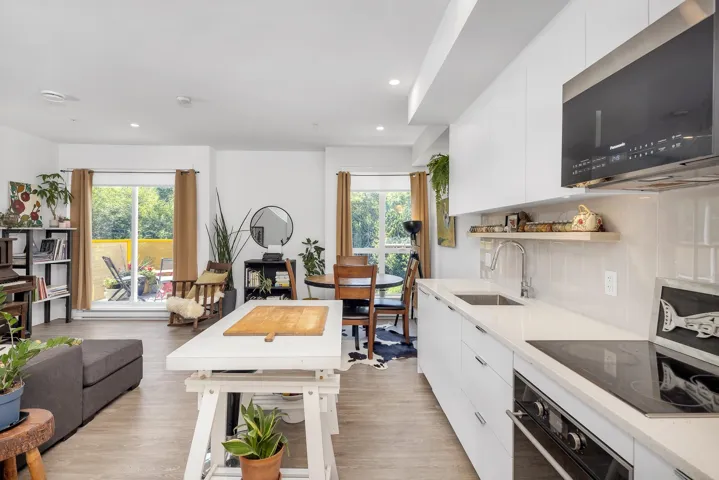 Kitchen with white cabinetry, stainless steel microwave, modern cabinets, oven, and recessed lighting