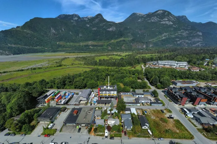 Aerial view of property and surrounding area with a mountainous background